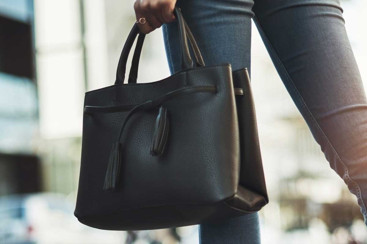 Woman carries black bag